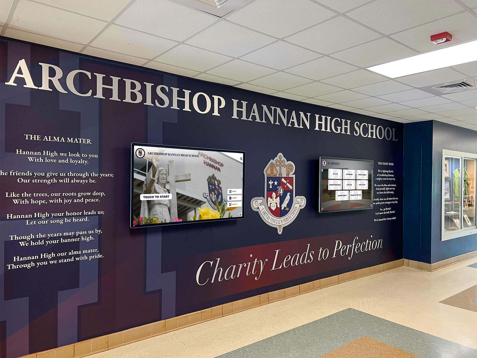 Archbishop Hannan High School lobby mural with crest and digital screens