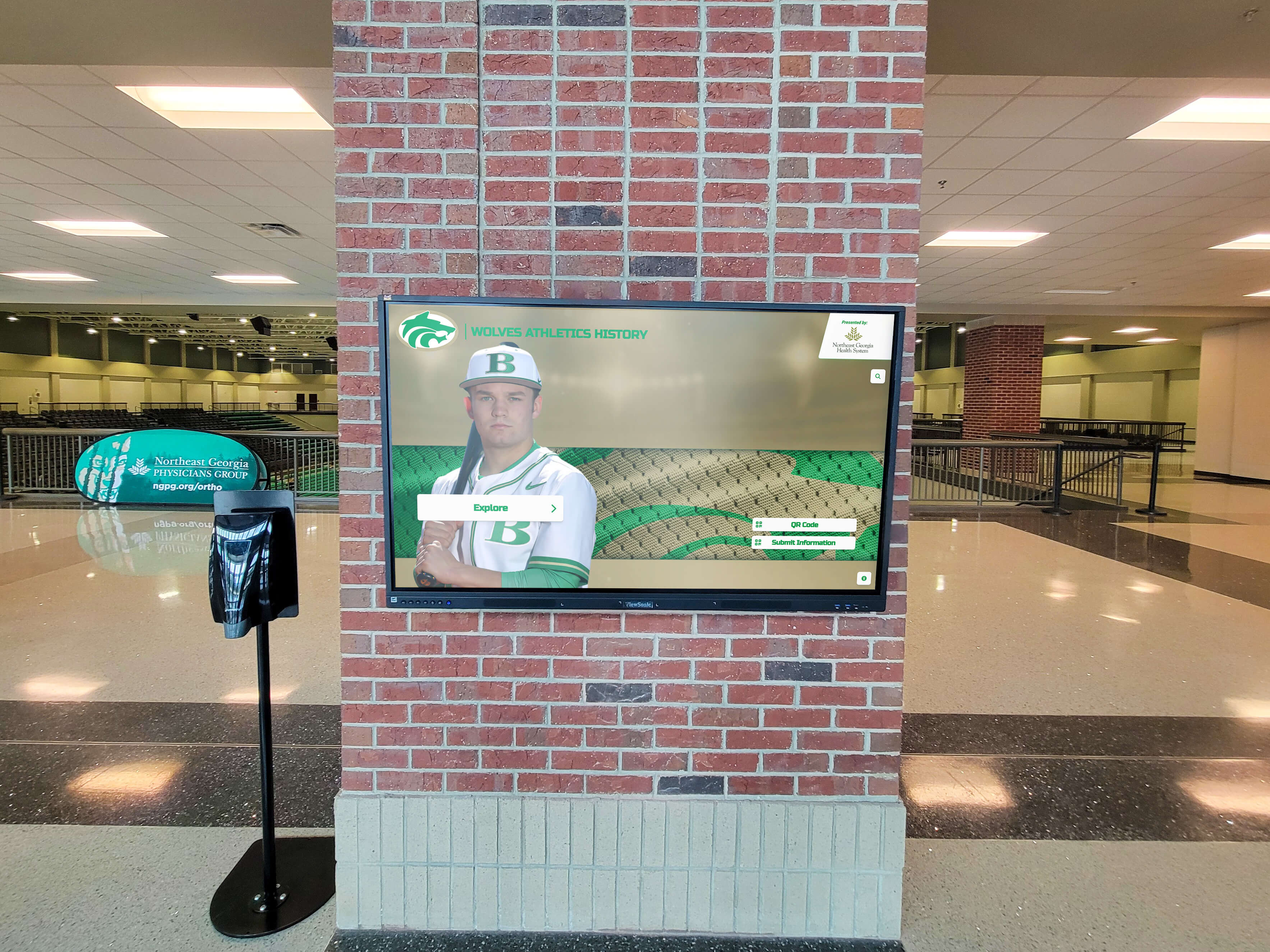 Large-format digital display showing athlete in arena setting Digital athletic display in lobby