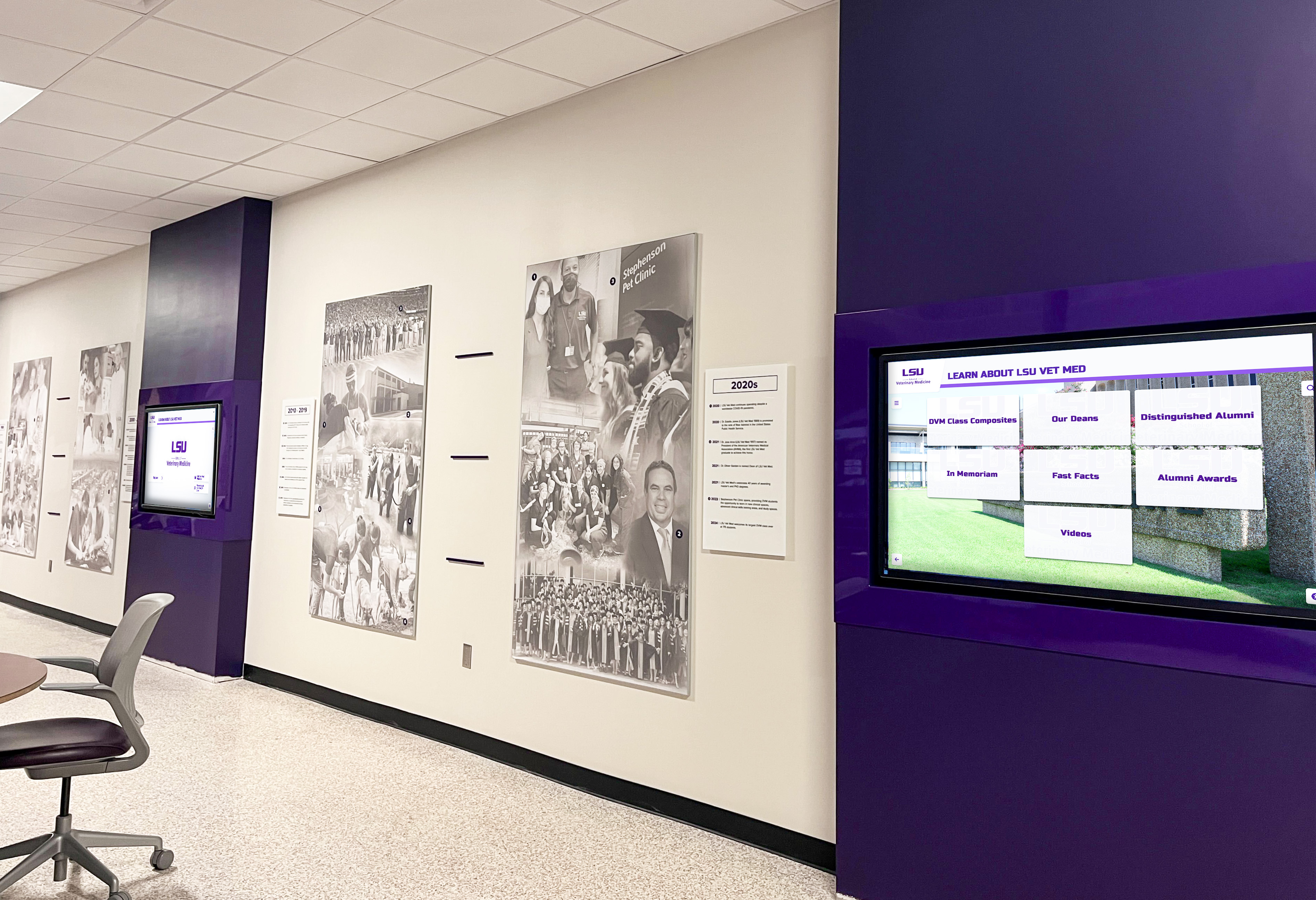 School hallway digital displays showcasing program identity, histories, and achievements Digital display in school hallway showcasing program histories and achievements