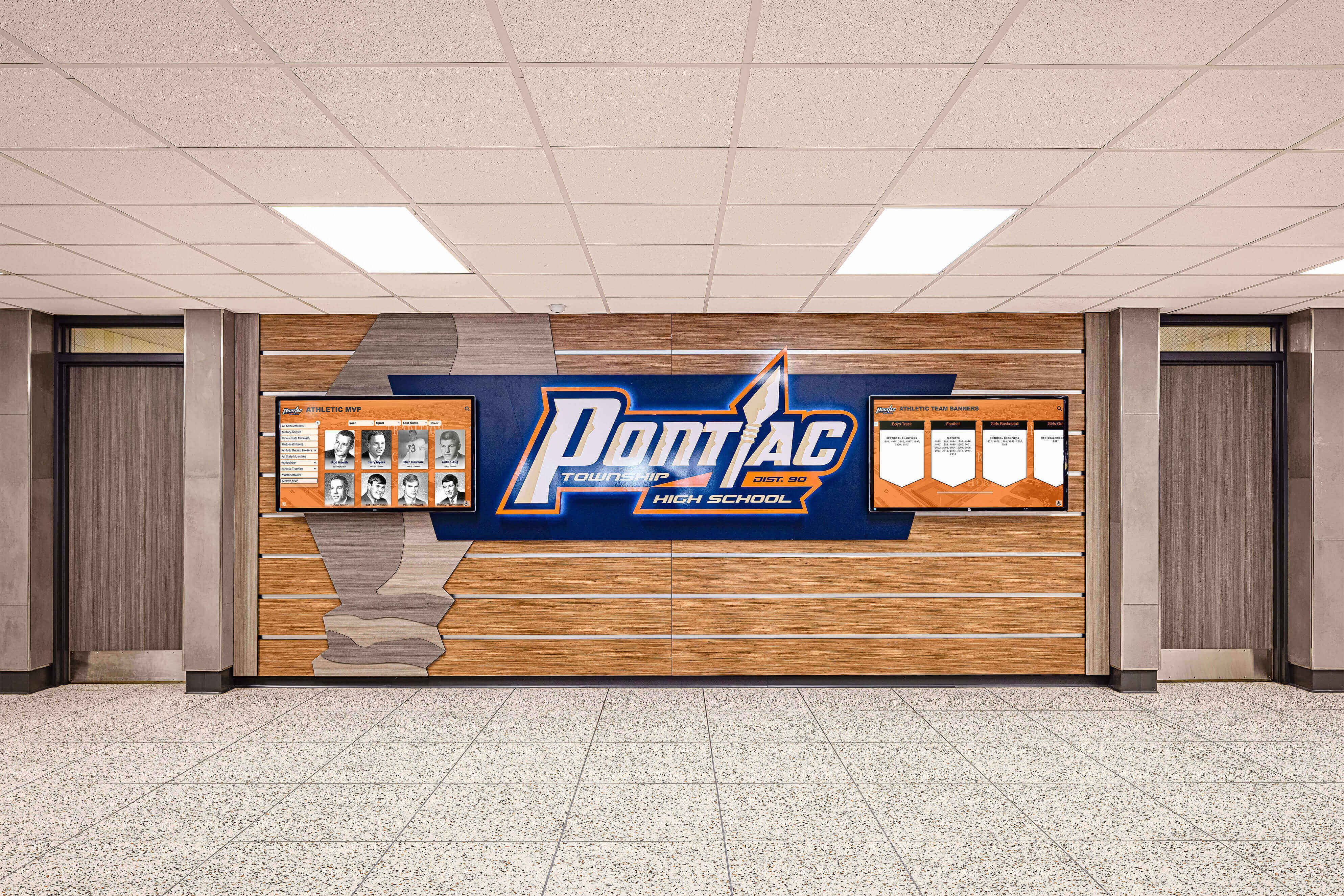 Recognition wall featuring digital displays and honor boards