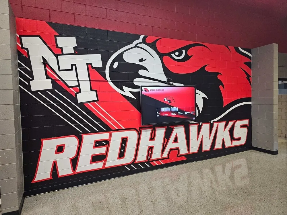 School hallway with Redhawks athletic mural
