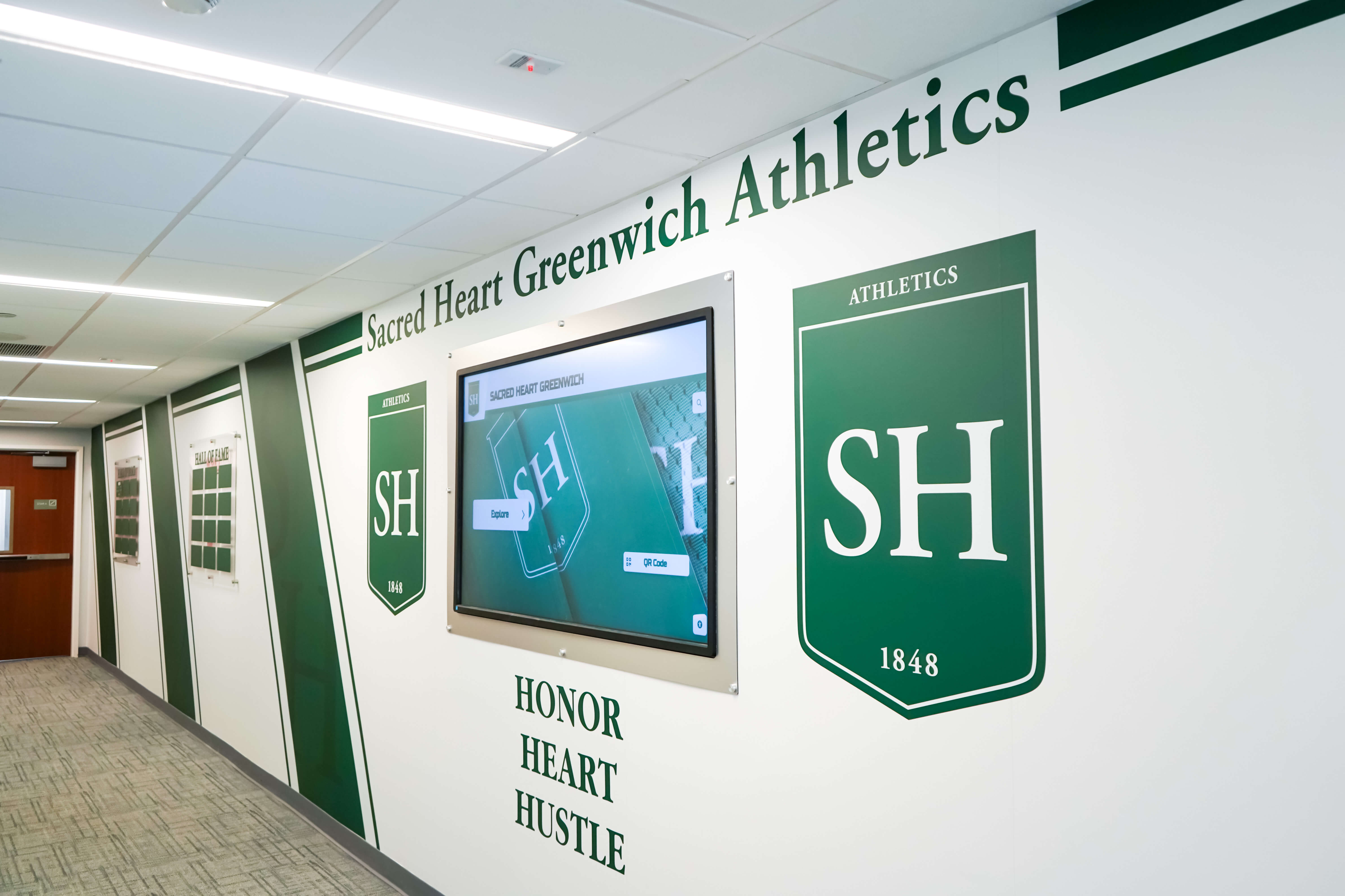 Sacred Heart Greenwich athletics hallway shield display recognizing student achievement